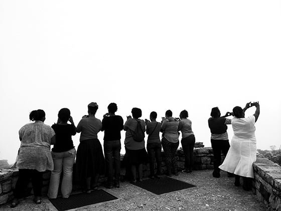 The ladies taking photos from the top of Table Mountain in Cape Town, South Africa.
