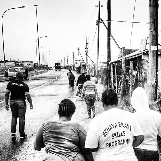 The ladies walk back to the van after photographing shops in Khayelitsha, South Africa. Photo by Andrea Rees.