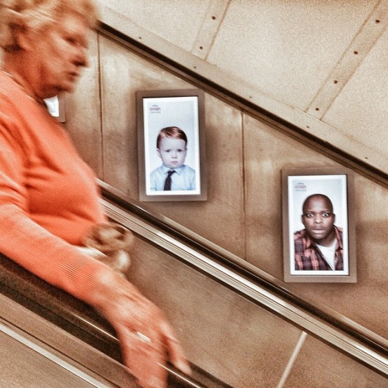 Faces on the escalator by Richard Gray