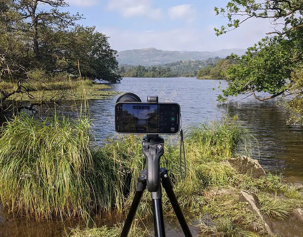 iPhone mounted on a tripod filming a timelapse using the Reelapse app